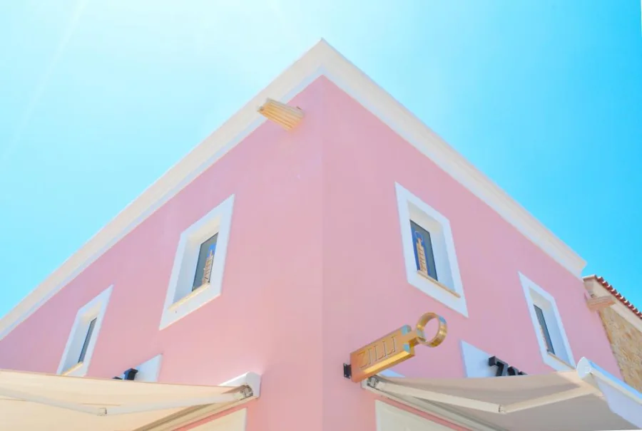 A freshly painted building facade against a blue sky